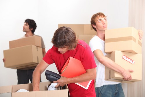 Loading furniture and boxes into a moving truck near Brompton properties