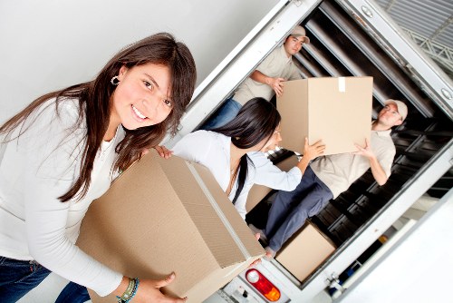 Van-based moving service handling boxes and furniture near Brompton